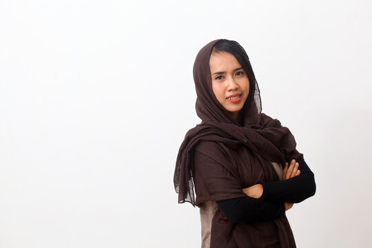 A portrait of happy asian muslim woman wearing a veil or hijab smiling and looking at the camera. Isolated on white background with copy space