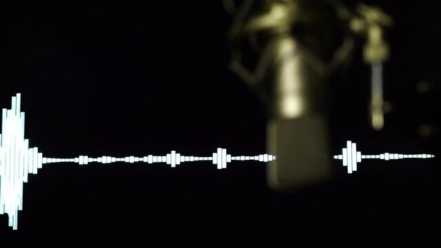 in the recording room A professional team is recording with a condenser microphone. and there is a monitor showing the sound wave in the back.