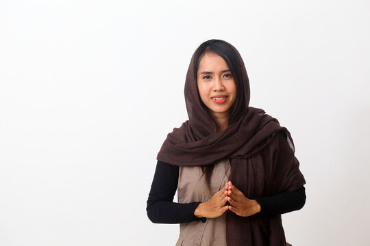 Portrait of happy asian muslim woman wearing a veil or hijab smiling and looking at camera. Isolated on white background with copy space