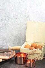 Fototapeta na wymiar Set of baking utensil store with eggs in vintage kitchen style in front view.