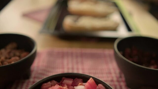 Three traditional Mexican molletes on a black tray