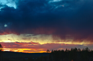 Sunset above road and forest warm evening