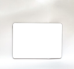 The tablet is black on a white isolated background with a mock up. Back side view of the tablet