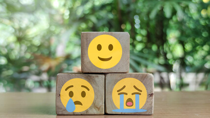 best excellent business services rating customer experience. Satisfaction survey concept. Hand of a woman chooses a smiley face on wood block cube.