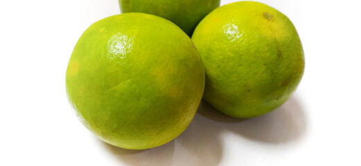 Green orange isolated on plain white background. photo of three fresh green oranges.