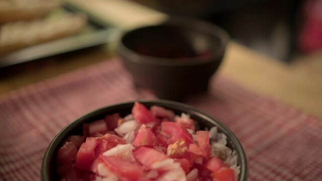Traditional Mexican mollete on a plate above white and red checkered napkin