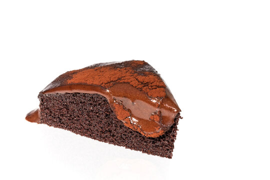 Slice of Chocolate Cake with molten ganache isolated in white background.