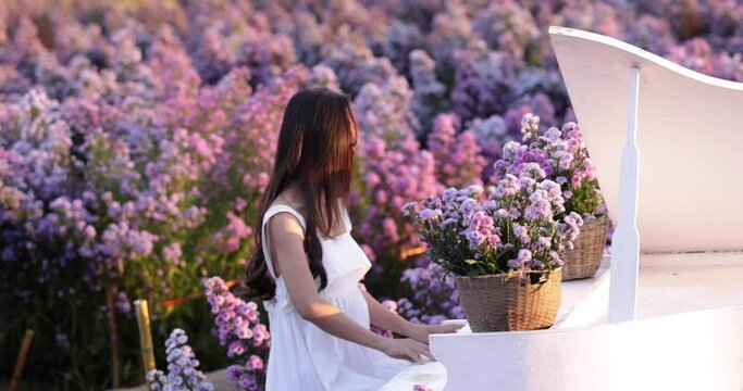 young asian girl in white wedding dress relaxing in the flowers garden 4k video slow motion 