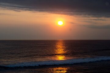 Sunset over the ocean. The sun sky sea at sunset sunrise background. Calm beach with light over...