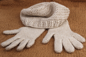 Close-up of crocheted woolen gloves and hat. Winter clothing.