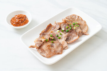 grilled pork neck sliced on plate