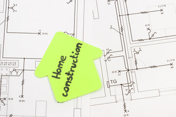 House shape made of paper with inscription home construction and electrical housing plan. Building...