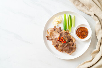 grilled pork neck sliced on plate