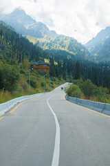 Fototapeta premium long road and high mountains in summer. High quality photo