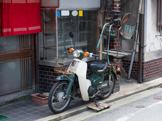 ラーメン屋の店先の出前機が付いたバイク