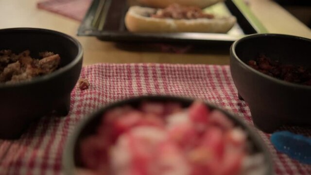 Three traditional Mexican molletes on a black tray