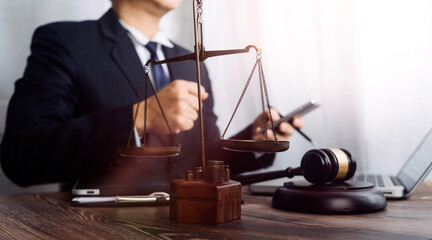 Justice and law concept.Male judge in a courtroom with the gavel, working with, computer and...
