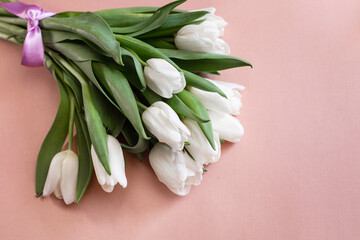 Fototapeta premium bouquet of delicate tulips on a beige background.