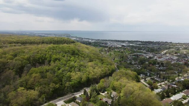 Beautiful aerial flight over natural forest near Grimsby City and Lake Ontario in background. Hamilton,Canada.