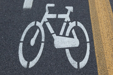 Naklejka premium White bycicle sign on a concrete lane
