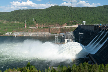 A long plume of water discharged from a hydroelectric power plant.