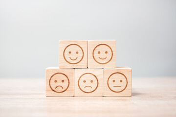 emotion face symbol on wooden blocks. Service rating, ranking, customer review, satisfaction,...