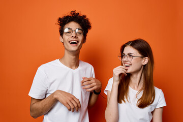 cheerful young couple in white t-shirts in lifestyle fashion emotions communication