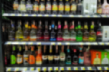 Collection of wines in the store of elite alcohol. Bottles of various wines are beautifully on the rack. Blur background.