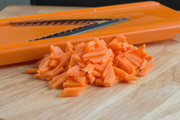 Fresh carrots are cut into strips on a special grater