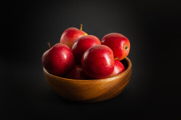 Red ripe apples on a black background.