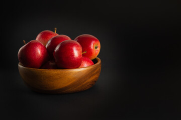 Red ripe apples on a black background.
