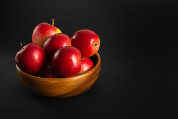 Red ripe apples on a black background.
