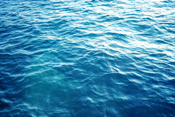 Photos of sea surface. Top view of sea water. Abstract natural blue wave splash background.