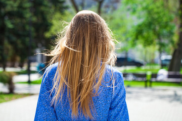 Back view blonde girl, summer park outdoor