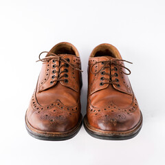 brown men's brogues on a white background close-up. classic men's shoes. mockup