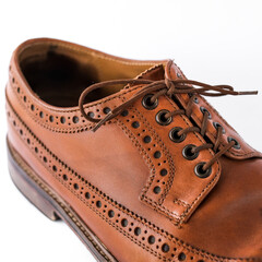 brown men's brogues on a white background close-up. classic men's shoes. mockup