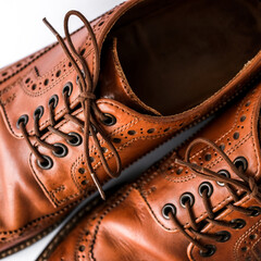 brown men's brogues on a white background close-up. classic men's shoes. mockup