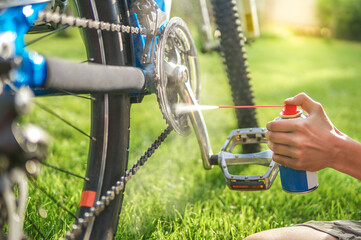 father and son maintain bike on a sunny summer day