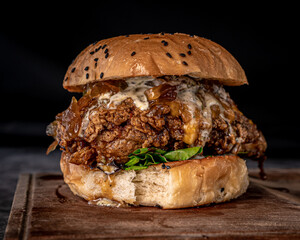 Appetizing crispy chicken burger on a plank