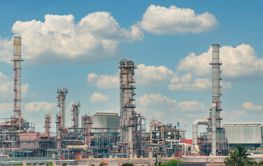 Oil refinery or petroleum refinery plant with blue sky background. Power and energy industry. Oil and gas production plant. Petrochemical industry. Natural gas storage tank. Petroleum business.