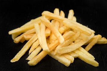 French fries on black background