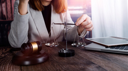 Business and lawyers discussing contract papers with brass scale on desk in office. Law, legal services, advice, justice and law concept picture with film grain effect