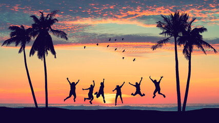 Silhouette happy friends jumping on sunset sky at tropical beach with palm tree and birds flying...