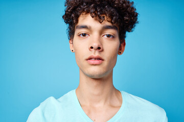 guy in blue t-shirt curly hair cropped view isolated background