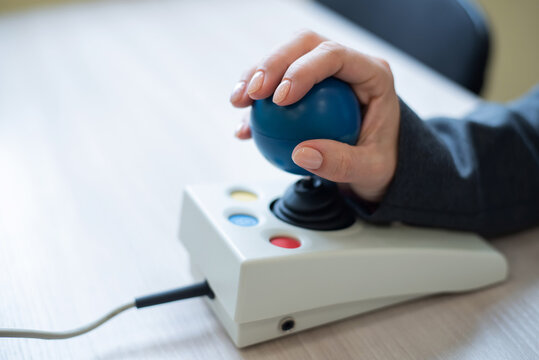 Woman With Cerebral Palsy Works On A Specialized Computer Mouse.