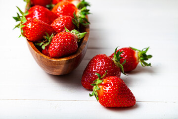 Ripe strawberries in a wooden bowl