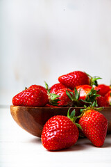 Ripe strawberries in a wooden bowl