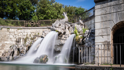 Royal Palace of (Reggia di) Caserta - The large basin of the park's artificial lake. The beautiful fountain with water coming out of the mouths of monstrous fish statues. Fountain of the three dolphin