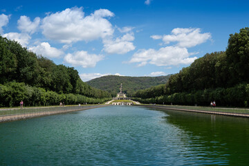 Royal Palace of (Reggia di) Caserta - The large basin of the park's artificial lake. The beautiful fountain with water coming out of the mouths of monstrous fish statues. Fountain of the three dolphin