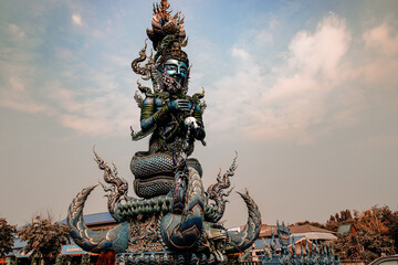 Low angle view of a giant Hindu sculpture in the famous Wat Rong Suea Ten or Blue Temple in Chiang...